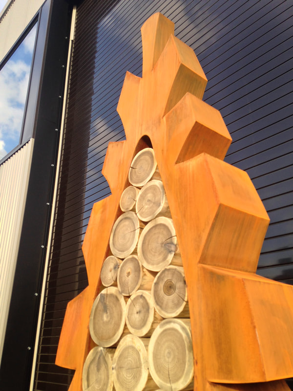 cor ten weathering steel sculpture pine cone shaped sculpture with cedar log inlay in st helena california fine art