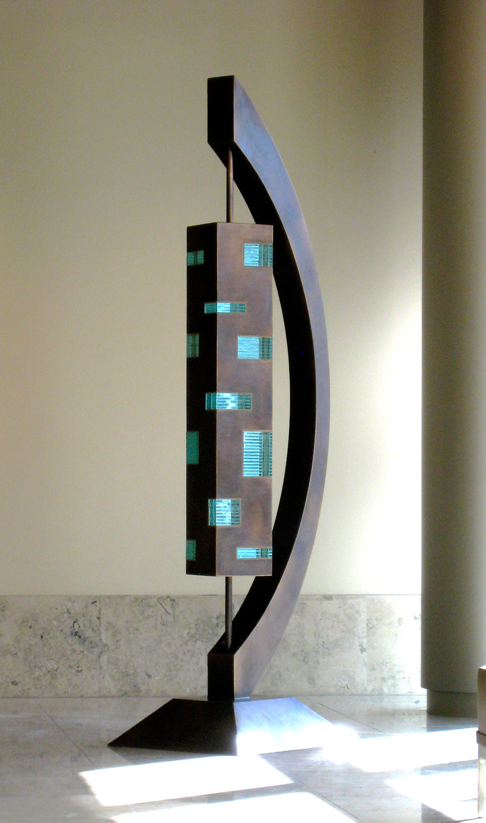 bronze glass rectangular sculpture that moves in hospital lobby